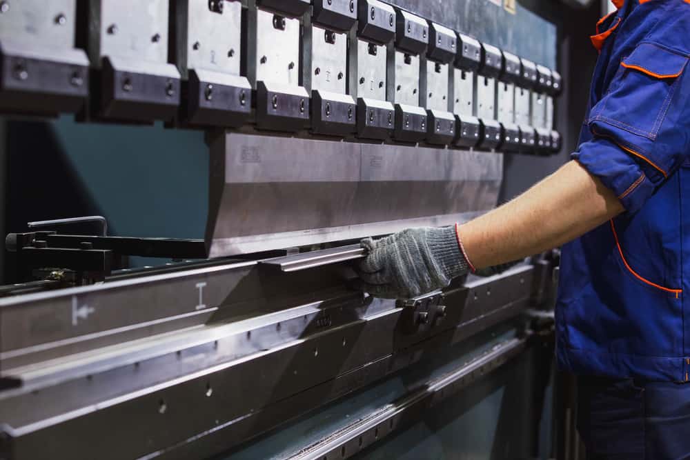 Man Working With Sheet Metal On CNC Hydraulic Press Brake